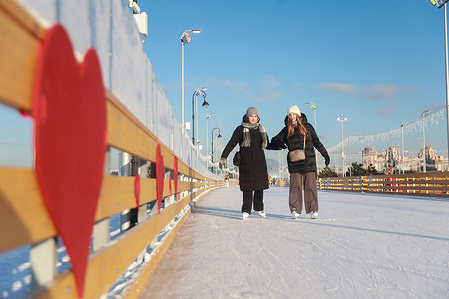A couple enjoy ice skating at the Flagstaff ice skating rink.