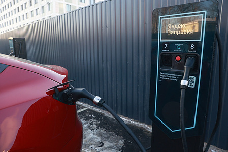 An electric vehicle is charging at Yandex Zapravki high-speed Electric Vehicle Charging station.