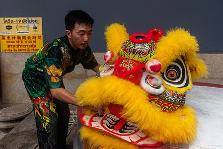 A lion dancer prepares before the performance during the Chinese Lunar new year celebration at the Chinese shrine in Chinatown, Bangkok. The Chinese Lunar New Year on 10 February 2024 marks the beginning of the Year of the Dragon.