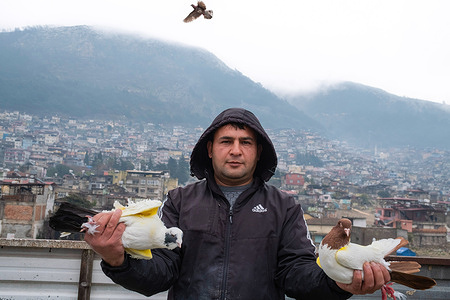 Pigeon breeder Huseyin Kaya seen holding pigeons in his hands. Despite the devastation wrought by the two earthquakes in Turkey on Feb 6, 2023, 36-year-old Huseyin Kaya refused to abandon his passion for pigeon breeding. He had nurtured this interest since the tender age of 11. Amidst the chaos of the earthquake, which claimed the lives of many of his relatives, Kaya finds solace and purpose in caring for his pigeons, striving to rebuild his life amidst the ruins left by the tremors.