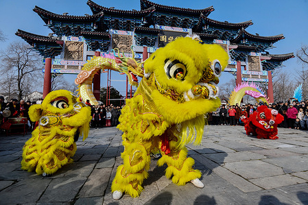 Folk performers perform a lion dance at the square, an important traditional performance in China to celebrate the Chinese New Year, the Spring Festival.