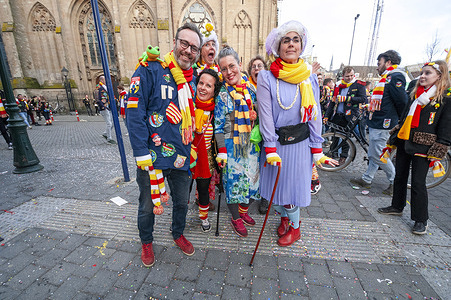 Visitors and partygoers pose for a photo during Carnival 2024 in the city center of Den Bosh. Due to the significant influx of visitors expected this year, the municipality has appealed to potential attendees, asking if they could consider canceling their visit. The Oeteldonk Carnival is officially celebrated from Sunday, February 11th to Tuesday, February 13th. The Carnival holds a rich tradition in Den Bosch, spanning over 550 years, and it draws numerous visitors from outside the city each year.