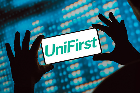 In this photo illustration, the Unifirst Corporation logo is displayed on a smartphone screen.