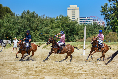 Polo players from Captain Baxter and Whispering Angel team are seen in action in a polo game at the Luxury Escapes Twilight beach polo 2024.