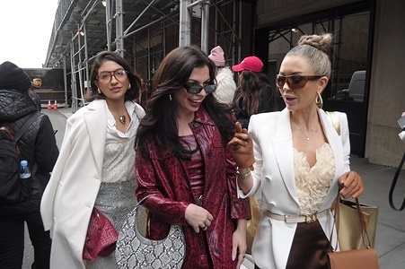 People walk down the street outside of the Pamella Roland fashion show at the Starrett-Lehigh Building during New York Fashion Week in New York City.
