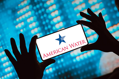 In this photo illustration, the American Water Works Company logo is displayed on a smartphone screen.
