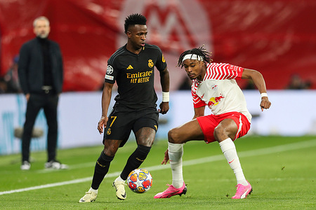 Vinicius Junior of Real Madrid (L) and Mohamed Simakan of RB Leipzig (R) seen in action during the UEFA Champions League match between RB Leipzig and Real Madrid at RedBull Arena. Final score; RB Leipzig 0:1 Real Madrid.