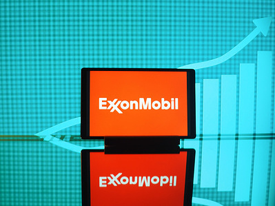 In this photo illustration, Exxon Mobil Corporation logo seen displayed on a tablet.