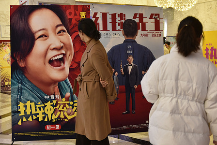 Movie viewers walk past the recently released posters of "You Only Live Once" and "The Movie Emperor" at the cinema. From Feb 10, the Spring Festival holiday will start up to Wednesday, Chinese cinemas grossed over 5.7 billion yuan ($792.4 million). The take represents a 21 percent increase over the same five-day period last year, according to the movie information live tracker Beacon. The holiday will end on Saturday.