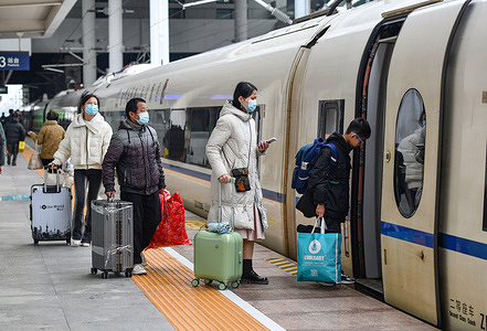 At the high-speed train station, passengers are seen with suitcases ready to take the high-speed train from home to the city where they work. The Chinese New Year holiday is coming to an end, and people are leaving their hometowns to return to the cities where they work, which is putting some pressure on China's transport systems.