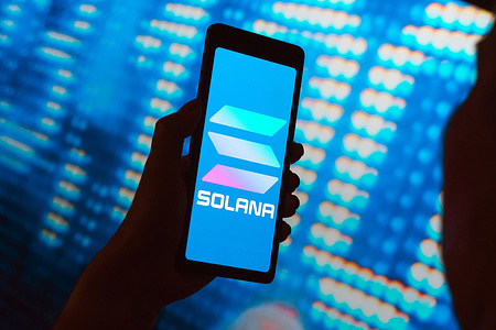 In this photo illustration, the Solana logo is displayed on a smartphone screen.