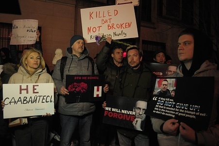 Demonstrators hold placards expressing their opinions of Alexei Navalny and Vladimir Putin during a vigil for Navalny. The vigil took place outside the Consulate General of the Russian Federation in the borough of Manhattan in New York City. According to a report by the Russian prison service, Alexei Navalny, a former lawyer and critic of Vladimir Putin, died in jail in a Russian penal colony north of the Arctic Circle. U.S. President Joe Biden blamed Putin for Navalny's death. Navalny was serving a combined prison sentence of more than 30 years.