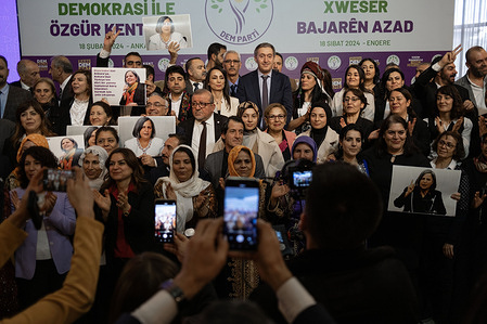 Journalists take photos of DEM party members after the event. Turkey’s opposition Peoples’ Equality and Democracy (DEM) Party revealed its manifesto for Turkey's March 31 local elections in Ankara during an event on Feb 18. Co-chairs Bakırhan and Hatimoğulları highlighted projects benefiting women, children, the disabled, youth, and the elderly. They honored imprisoned politician Gültan Kışanak, an Ankara co-mayoral candidate, by placing her photo on an empty chair. Earlier on Feb 17, the party had announced Kışanak's candidacy despite her imprisonment.