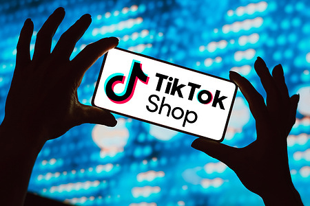 In this photo illustration, the TikTok Shop logo is displayed on a smartphone screen.