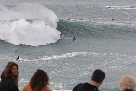 Spectators watch the big wave surfers at Praia do Norte in Nazaré.