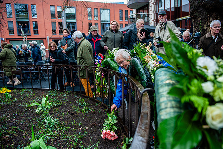 An old lady is seen trying to put a bunch of flowers at the monument during the commemoration. The 80th commemoration of the Bombing of Nijmegen which was unplanned attack by American aircraft on the city of Nijmegen, on 22 February 1944. The attack is believed to have resulted in at least 800 recording deaths and was one of the most significant bombings of any Dutch city. Every February 22nd an official commemoration takes place at the Raadhuishof, the location where a Montessori school was located, and where 24 children and 8 sisters were killed. There a monument called "De Schommel" was erected to remember the raid on the civilian casualties.