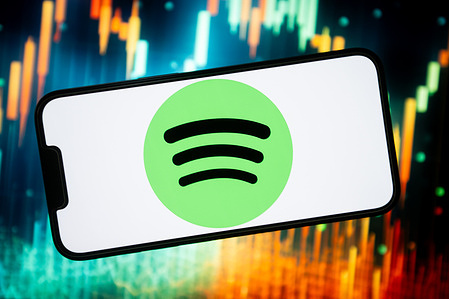 In this photo illustration, a Spotify logo seen displayed on a smartphone.