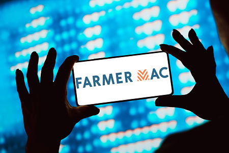 In this photo illustration, the Farmer Mac logo is displayed on a smartphone screen.