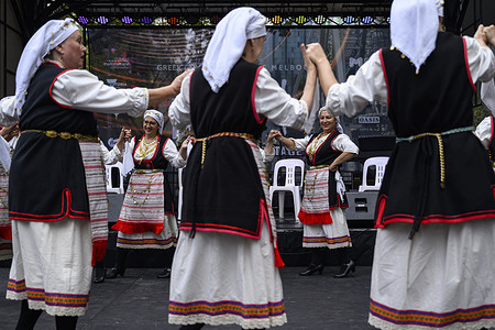 A dance group performs a traditional Greek dance on stage. The Antipodes Festival in Melbourne is the largest celebration of Greek culture in Australia. The two days festival features cultural displays, traditional Greek dances, live music performances, and authentic Greek cuisine from local vendors.