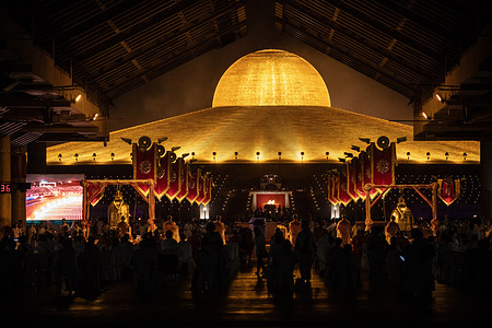 A view of the temple during the yearly ceremony of Makha Bucha at Wat Dhammakaya in the north of Bangkok. Thai people celebrate the Buddhist festival of clockwise circumambulation and Makha Bucha lantern lighting ceremony at Dhammakaya Temple on 'Makha Bucha Day' during the third lunar moon, where around 5000 monks gathered to be ordained by the Buddha and 35000 devotees holding lanterns.