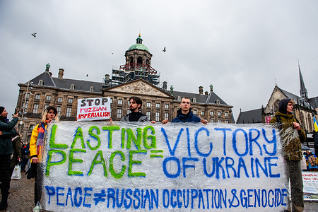 Protesters hold a big banner asking for peace in Ukraine during the rally. Because today marks two years since Russia started its war against Ukraine, in Amsterdam, thousands of Ukrainian people and supporters walked from the Museumplein to Dam Square to remind the Dutch society that the war keeps going and that Ukraine needs support with that. Over eight million people have been forced to leave Ukraine, and another five million have been internally displaced.