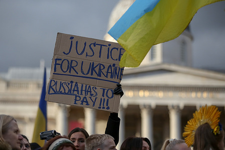 A Ukrainian holds a placard during a rally in Trafalgar Square, London to mark the second anniversary of Russian invasion of Ukraine.