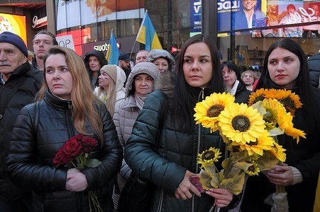 Pro-Ukraine demonstrators at a rally in Times Square hold sunflowers, the national flower of Ukraine. Demonstrators rallied in Manhattan, New York City on the two-year anniversary of the Russian invasion of Ukraine. Protestors condemned the invasion and opposed Russian President, Vladimir Putin. Last weekend, Russian forces captured the eastern Ukrainian city of Avdiivka located on the front line. The loss of the city comes as a $60 billion aid package for Ukraine from the United States has been stalled following disagreements in Congress. Ukrainian President, Volodymyr Zelenskyy, said Ukrainian troops face challenges defending parts of the front line due to ammunition shortages.