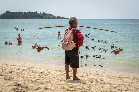 A Thai beach seller seen at the beach of Koh Chang Island.