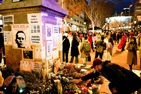 A man lays flowers on a makeshift altar after the death of Russian opposition leader Aleksei Nalvany in Barcelona. The Russian and Ukrainian community pay tribute to Russian opposition leader Aleksei Navalny, weeks after Russia announced his death in a Russian prison. Some people have gathered to bring flowers, candles and other personal items to pay tribute at a makeshift altar in Las Ramblas, Barcelona.