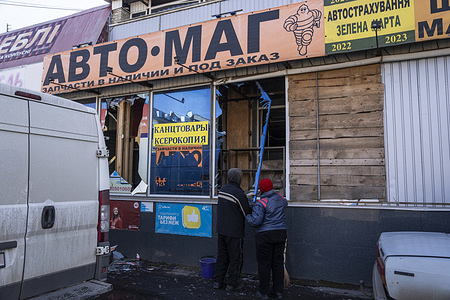 Local residents remove a shattered window frame from a car shop that was damaged by a Russian strike on the nearby train station in Kostiantynivka. The Kostiantynivka train station, in Ukraine’s Donbas region, was hit by a Russian missile overnight, the day after the second anniversary of Russia’s full-scale invasion of Ukraine.