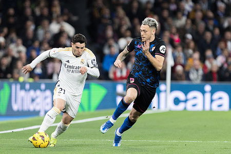 Brahim Diaz of Real Madrid and Lucas Ocampos of Sevilla in action during the La Liga 2023/24 match between Real Madrid and Sevilla at Santiago Bernabeu Stadium. Final score; Real Madrid 1:0 Sevilla