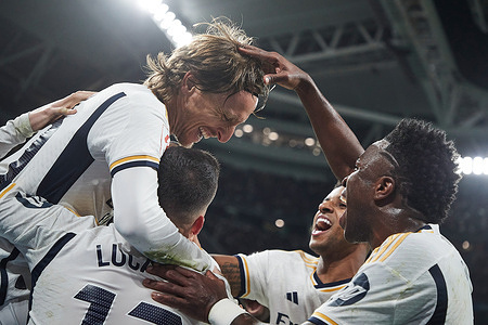 Luka Modric (L) of Real Madrid CF celebrates a goal against Sevilla FC with Vinicius Junior (R), Rodrygo Goes of Real Madrid CF (C) and Lucas Vazquez of Real Madrid CF (L2) during the LaLiga EA Sports week 26 football match between Real Madrid CF and Sevilla FC at Santiago Bernabeu Stadium. Final score: Real Madrid CF-Sevilla FC 1-0