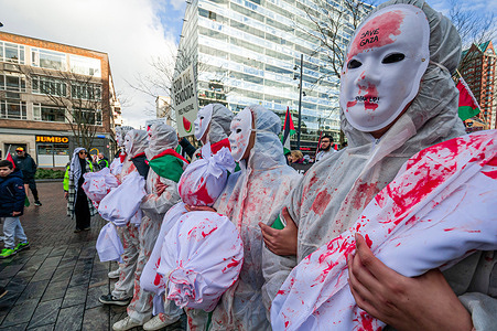 Demonstrators hold a dummy wrapped in fake blood-stained white cloth as a representation of war victims in Gaza, during the protest. Hundreds of Palestinians and their supporters gathered in Rotterdam for the "Hands off Rafah" demonstration, organized by the Rotterdam Palestine Coalition (RCP). The protest denounces the Dutch government's policy and its unwavering backing of Israel. Demonstrators demand a lasting ceasefire and the complete cessation of the Palestinian occupation. Despite the International Court of Justice's provisional ruling, Israel persists in its aggressive actions against men, women, and children. Palestinian health authorities report a staggering toll of at least 29,692 casualties and 69,692 injuries since October 7, 2023.