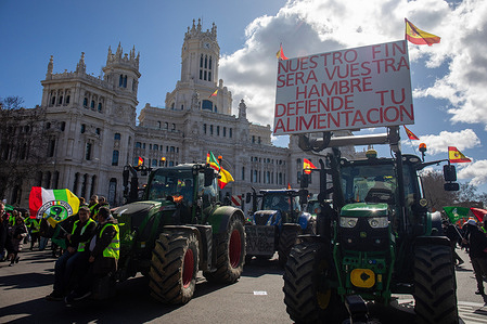 Tractors circulate in front of the Cibeles Palace during the demonstration. Hundreds of ranchers and farmers demonstrated with their tractors through the streets of the center of Madrid. They traveled from the Ministry of Agriculture to the offices of the European Commission Representation in Spain.