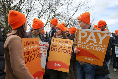 Protesters hold placards expressing their opinions during the demonstration. Members of the British Medical Association (BMA) staged their 10th junior doctors' strike outside St Thomas Hospital in Westminster, protesting pay and conditions. Tens of thousands of hospital appointments were canceled or postponed due to the industrial action taken by the junior doctors.