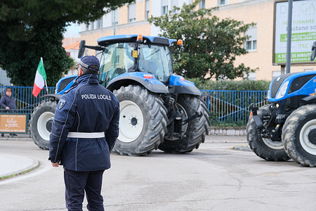 Police officers seen looking at the tractors during the march. All-out garrison and new protest procession of farmers. The demonstrators left the city center square and drove their tractors with flags, banners to the interior of the region, going to various locations in Molise to make their voice heard. Farmers are calling for greater protection and a change in European Union (EU) policies.