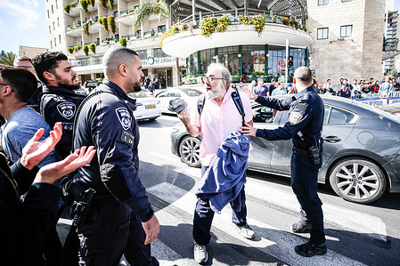 Israeli policemen intervene with an Israeli anti-war activist during the demonstration. Israeli anti-war activists staged a demonstration at West Jerusalem’s Paris Square near Israeli Prime Minister Benjamin Netanyahu's residence; calling for an end to Israel's escalating attacks in Gaza amid a deepening humanitarian catastrophe. Israeli police intervened in the demonstration and confiscated some placards and banners as some of the protesters confronted officers.