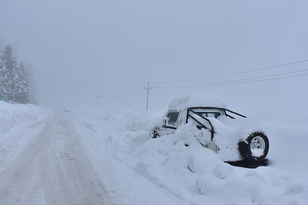 A vehicle is seen stuck and buried in snow during a snow storm in Gulmarg, a world famous ski-resort, about 55kms from Srinagar, the summer capital of Jammu and Kashmir.