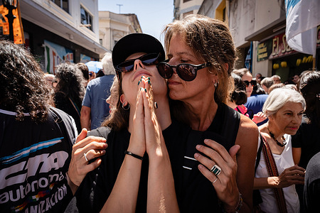 Two protesters embrace during the demonstration. Protesters gathered to demonstrate and show solidarity with the National News Agency Telam against the announcement of its closure and dismissal of its media workers made by the President of the Nation, Javier Milei.