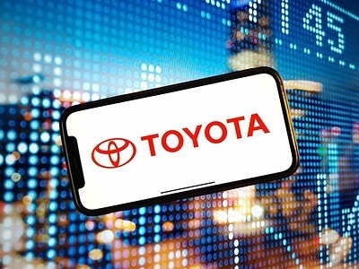 In this photo illustration, the Toyota company logo is seen displayed on a smartphone screen.