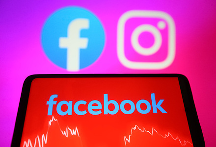 In this photo illustration, a Facebook logo is seen displayed on a smartphone screen and Facebook and Instagram logos on a pc screen. Facebook and Instagram of Meta are down worldwide, and users unable to access accounts, reportedly by media. WhatsApp and TikTok also crashed, reported by some media.