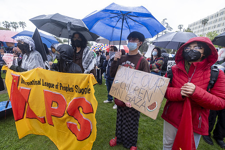 Protesters participate in a pro-Palestinian rally in the rain in Los Angeles.