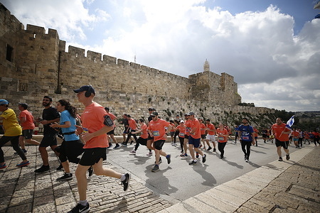 Runners take part during the International Jerusalem Marathon. People participate in the 13th annual International Jerusalem Marathon in Jerusalem. Many participants this year wore shirts and ran with signs raising awareness for the hostages kidnapped on October 7th by Hamas and still being held in Gaza. It was held in tribute to the Israel Defense Forces 'IDF' and security forces, amid the ongoing war with Hamas in Gaza.