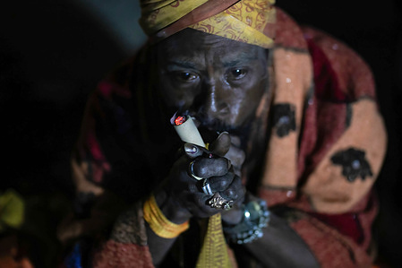 A Hindu holy man, or Sadhu, the follower of Lord Shiva, smokes marijuana on the Maha Shivaratri festival at the premises of Pashupatinath Temple. Hindu Devotees from Nepal and India come to this temple to take part in the Shivaratri festival which is one of the biggest Hindu festivals dedicated to Lord Shiva and celebrated by devotees all over the world.
