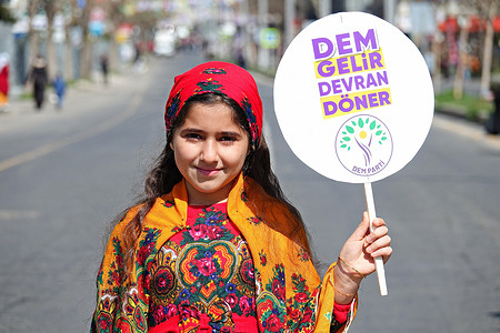 A Kurdish girl child, wearing her traditional wear is seen during the International Women's Day rally in Diyarbakir. International Women's Day was celebrated with a rally in Diyarbakir, Turkey, attended by hundreds of Kurdish women in their traditional clothing. The rally was organized by the Kurdish Free Women's Movement (Tevgera Jinên Azad-TJA) and the Women's Assembly of the Peoples' Equality and Democracy Party (DEM Party) under the slogan "Bi jin jiyan azadiye ber bi azadiye ve" (Towards freedom with 'women, life, freedom'). Speeches were made at the rally emphasizing the importance of women's struggle and a concert was performed by MA Music Group.