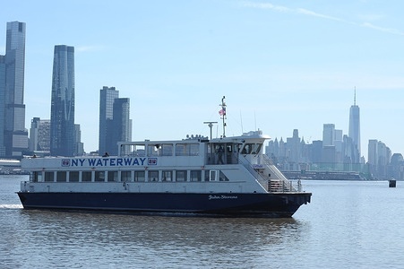 A New York Waterway ferry sails in the Hudson River as the New York City skyline is seen in the background.
