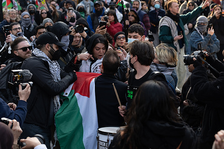 A female organizer is grabbed by a counter-demonstrator as he made his way through the crowd during the Global Strike for Gaza rally and march on International Women's Day in New York City on March 9th, 2024.