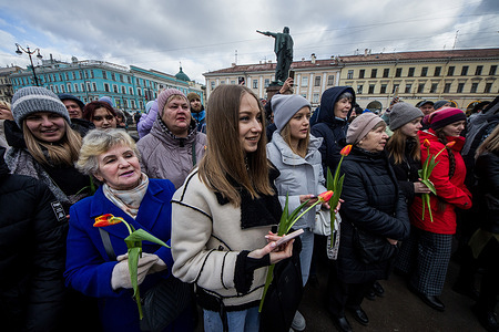 Citizens with flowers on the square near the Kazan Cathedral watch the performance of the Leningrad Military District dedicated to International Women's Day on March 8 in St. Petersburg. Celebrating International Women's Day on March 8 in St. Petersburg, Russia.