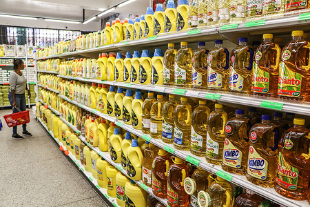 A woman compares cooking oil prices at a supermarket in Nakuru City. Kenya's inflation rate declined to 6.3% in February, down from January's 6.9%, according to data from the Central Bank of Kenya (CBK). This marks a 23-month low, attributed to a decrease in the cost of essential foods and fuel.