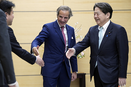 International Atomic Energy Agency Director General Rafael Mariano Grossi (L), introduces his staff to Japan Chief Cabinet Secretary Yoshimasa Hayashi (R), during their meeting at the prime minister's office in Tokyo.